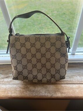 Gucci Beige and Brown Monogram small wrist bag.